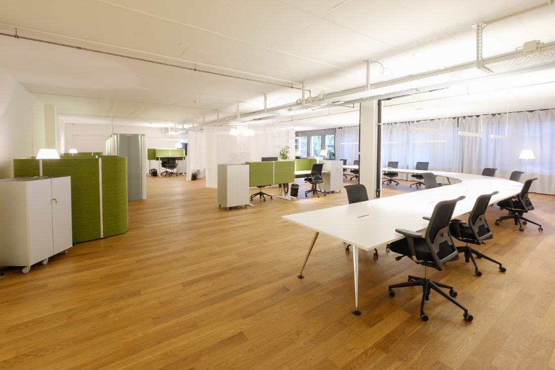 Open enterprise floor with desks and green dividers